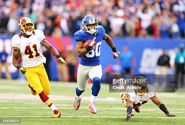Victor Cruz of the New York Giants runs after a catch for the winning touchdown as Madieu Williams, and Josh Wilson of the Washington Redskins give...