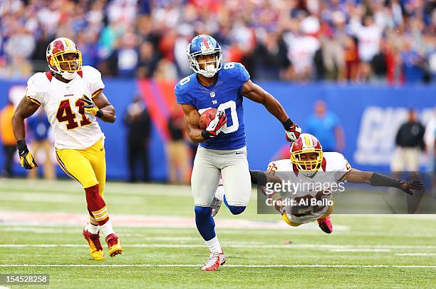 Victor Cruz of the New York Giants runs after a catch for the winning touchdown as Madieu Williams, and Josh Wilson of the Washington Redskins give...