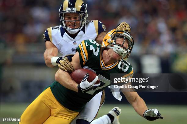 Wide receiver Jordy Nelson of the Green Bay Packers makes a nine yard pass reception as cornerback Cortland Finnegan of the St. Louis Rams is...