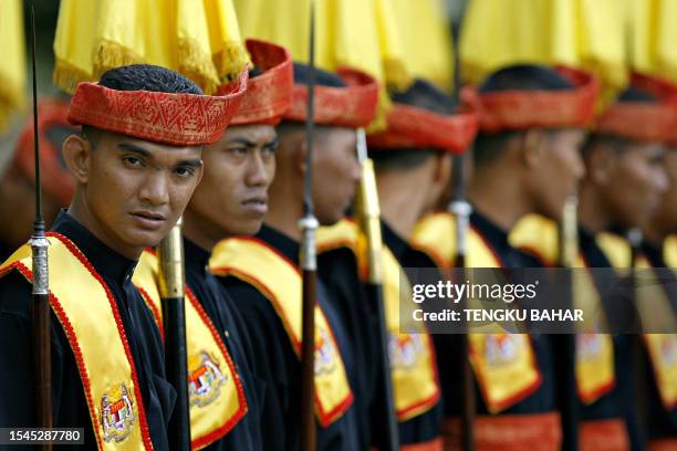 Royal Court guard stands at ease prior to the arrival of the King of Malaysia Tuanku Mizan Zainal Abidin at the Parliament in Kuala Lumpur, 19 March...