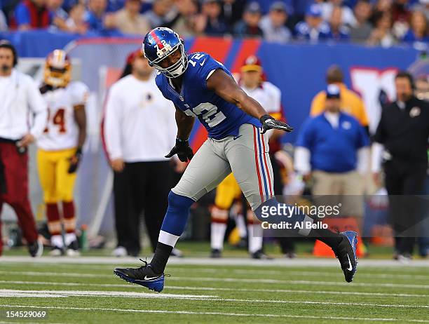 Osi Umenyiora of the New York Giants celebrates a sack against Robert Griffin III of the Washington Redskins during their game at MetLife Stadium on...