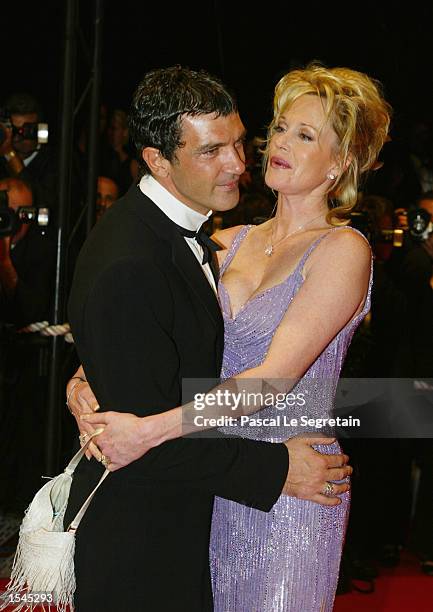 Actor Antonio Banderas hugs his wife actress Melanie Griffith as they arrive for the screening of Brian de Palma's film "Femme Fatale" at the 55th...