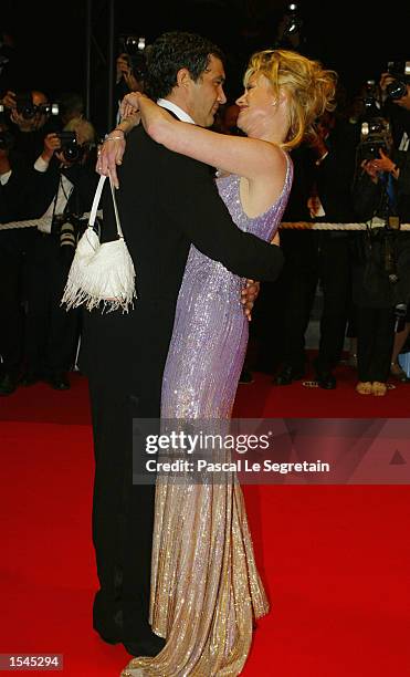 Actor Antonio Banderas hugs his wife actress Melanie Griffith as they arrive for the screening of Brian de Palma's film "Femme Fatale" at the 55th...