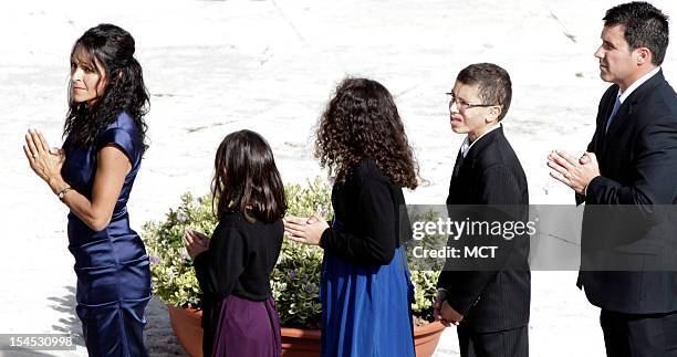 Jake Finkbonner, of Ferndale, Washington, second from right, and his relatives wait to receive the communion by Pope Benedict XVI, not pictured,...