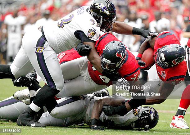 Ben Tate of the Houston Texans is tackled by DeAngelo Tyson of the Baltimore Ravens on October 21, 2012 at Reliant Stadium in Houston, Texas. Texas...
