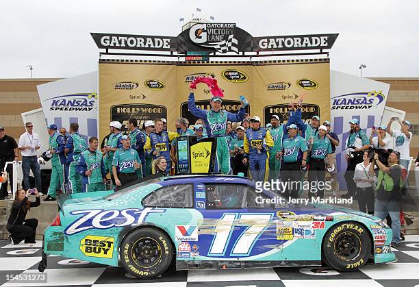 Matt Kenseth, driver of the Zest Ford, celebrates in Victory Lane after winning the NASCAR Sprint Cup Series Hollywood Casino 400 at Kansas Speedway...