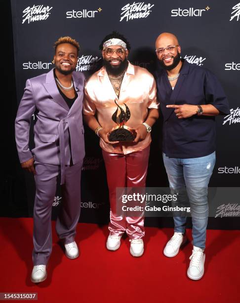 Travis Greene, Pastor Mike McClure Jr., winner of the Rap Hip Hop Song of the Year award, and James Fortune pose backstage during the 38th annual...