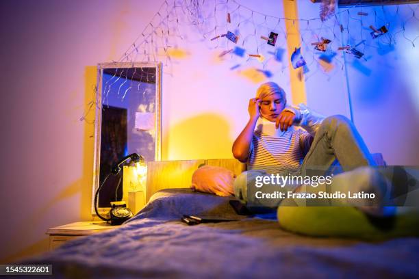 sad teenager with a neck brace feeling a headache at home - boy broken arm stock pictures, royalty-free photos & images