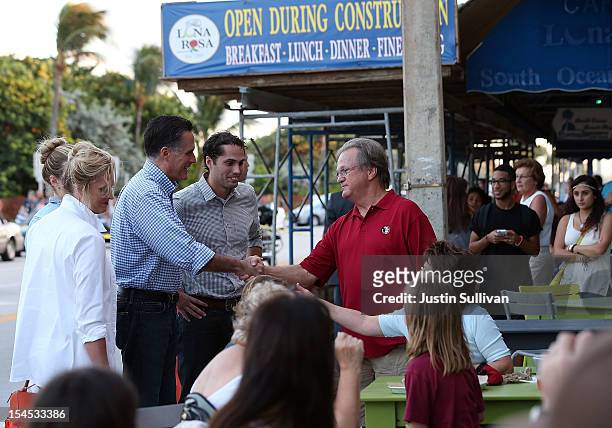 Ann Romney, Republican presidential candidate, former Massachusetts Gov. Mitt Romney and Craig Romney greet patrons at BurgerFi on October 21, 2012...