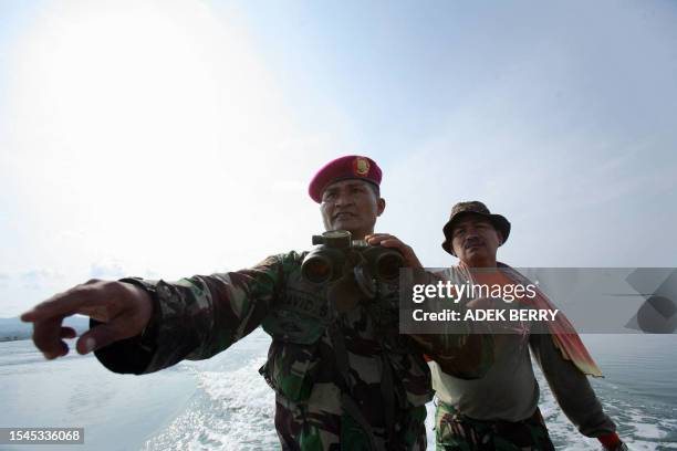 An Indonesian Marine soldier gestures as the search continues for the missing Adam Air Plane in Barru, 12 January 2007. Part of the wreckage of the...