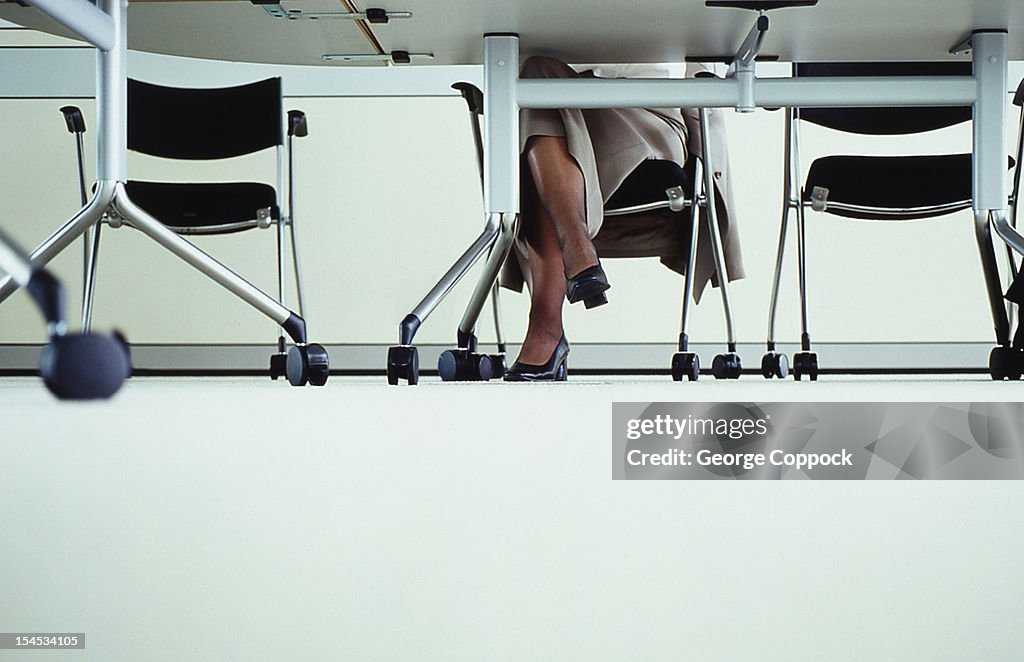 Business Women's legs under table