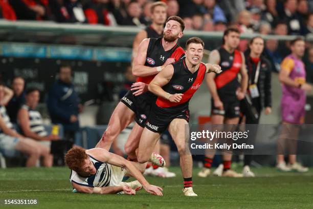 Jayden Laverde of the Bombers collides with Gary Rohan of the Cats and Zach Merrett of the Bombers during the round 18 AFL match between Geelong Cats...
