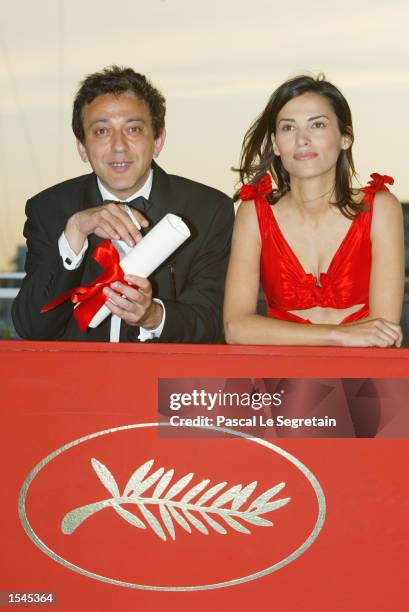 Jury prize winner Palestinian actor and director Elia Suleiman holds his award as Palestinian actress Manal Khader stands next to him at the 55th...