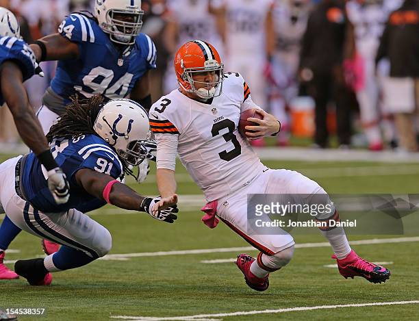 Brandon Weeden of the Cleveland Browns slides for a first down past Ricardo Mathews of the Indianapolis Colts at Lucas Oil Stadium on October 21,...