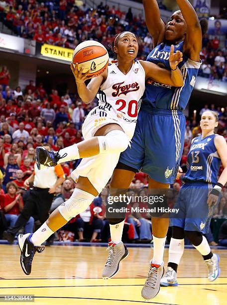 Briann January of the Indiana Fever shoots the ball against Taj McWilliams-Franklin of the Minnesota Lynx during Game Four of the 2012 WNBA Finals on...