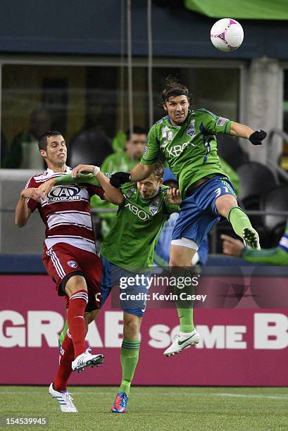 Matt Hedges, of FC Dallas, plays defense as Adam Johansson and Jeff Parke, of the Seattle Sounders are first to the ball in first half action at...