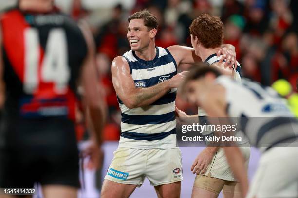 Tom Hawkins of the Cats celebrates the goal of Gary Rohan of the Cats during the round 18 AFL match between Geelong Cats and Essendon Bombers at...