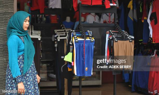 This picture taken in Jakarta on October 21, 2012 shows an Indonesian vendor waiting for customers at a small entreprise village. Indonesia's...