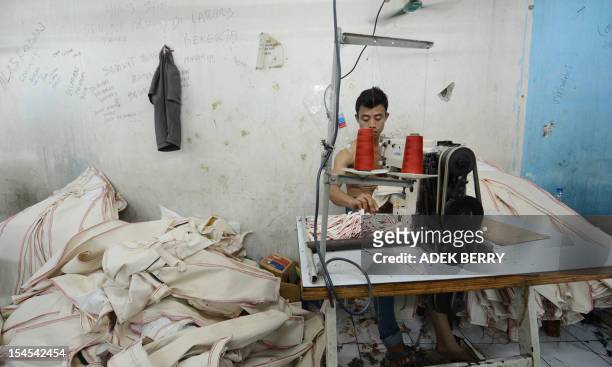 This picture taken on October 21, 2012 shows an Indonesian worker is working at a workshop in a small entreprise village in Jakarta. Indonesia's...