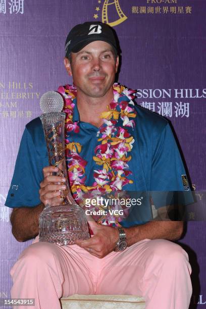Golfer Matt Kuchar of USA poses with the trophy after winning the Mission Hills Star Trophy at the Mission Hills Golf Club on October 21, 2012 in...