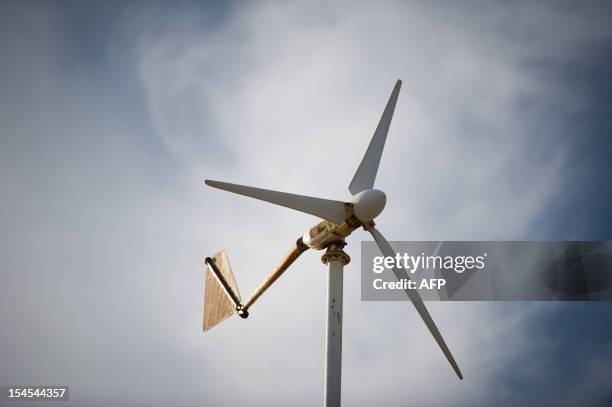 Wind turbine is seen set on the roof of a local residence in Lauro de Freitas, state of Bahia, northeastern Brazil, on December 1, 2011. At a cost of...