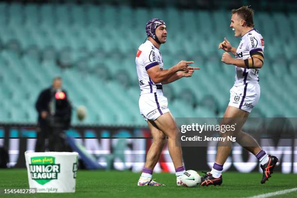 Jahrome Hughes of the Storm celebrates scoring a try during the round 20 NRL match between Sydney Roosters and Melbourne Storm at Sydney Cricket...