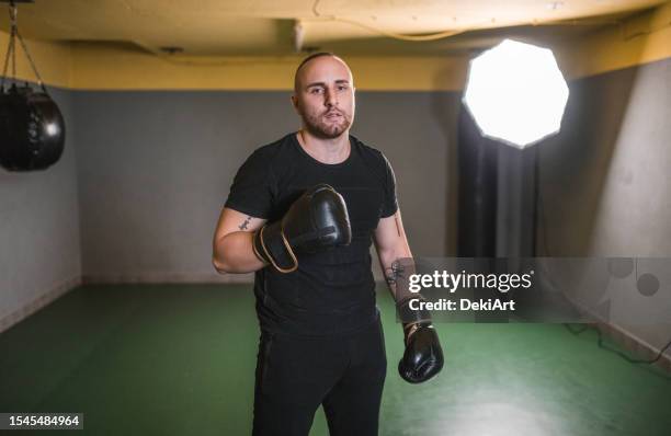 confident man boxer with boxing gloves is training in the boxing gym - self improvement stock pictures, royalty-free photos & images