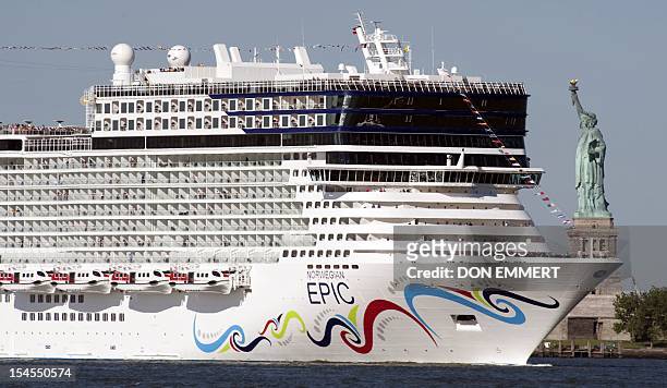 The cruise ship Norwegian Epic sails past the Statue of Liberty July 1, 2010 in New York Harbor. The Norwegian Cruise Line ship, on her Maiden Voyage...
