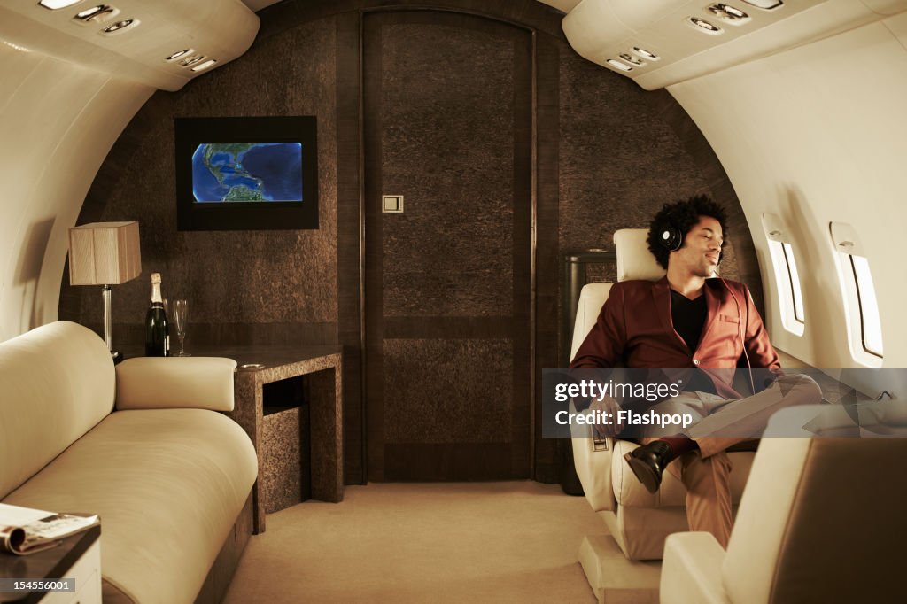 Man listening to music on private jet