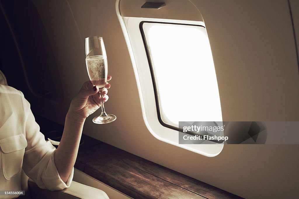 Businesswoman relaxing aboard private jet