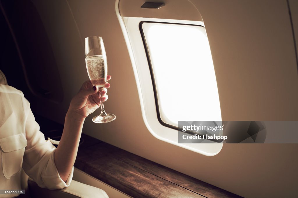 Businesswoman relaxing aboard private jet