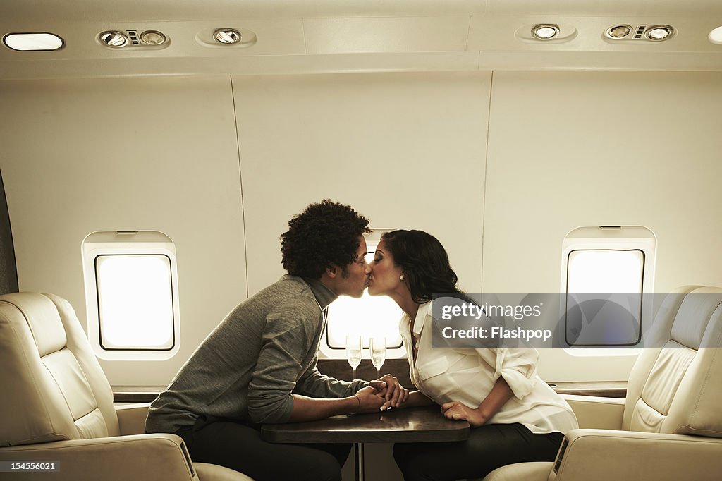 Couple kissing on private jet