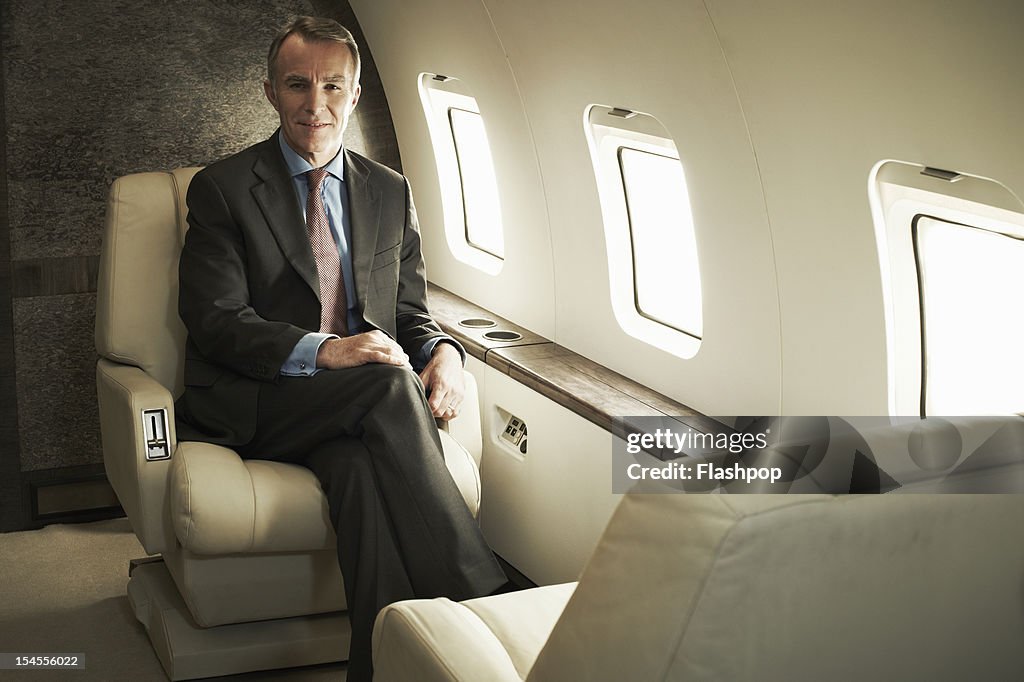 Business man travelling aboard a private jet