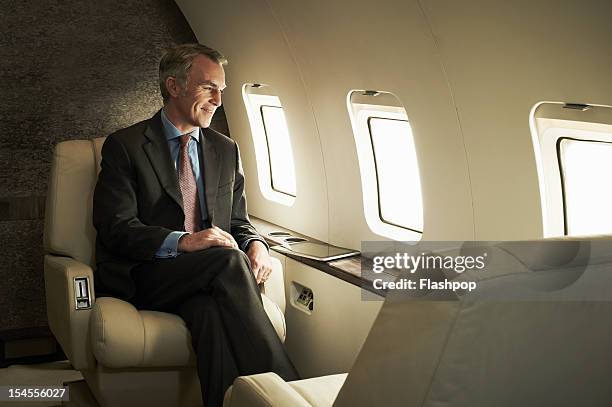 business man travelling aboard a private jet - millionnaire ストックフォトと画像