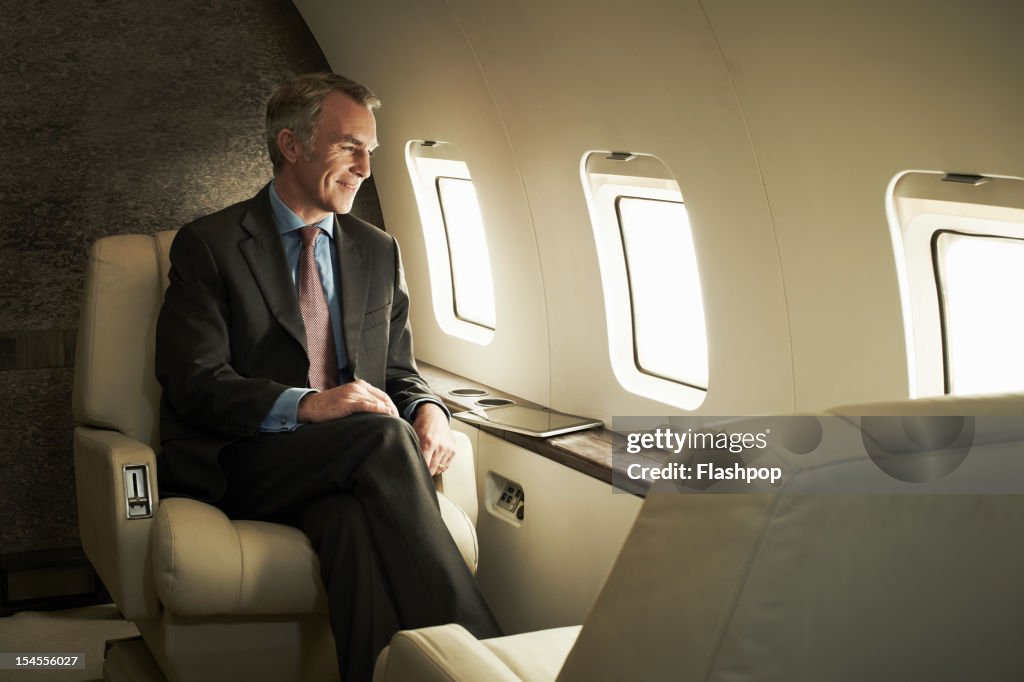 Business man travelling aboard a private jet