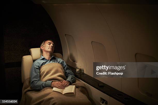 businessman sleeping aboard private jet - vehicle interior bildbanksfoton och bilder