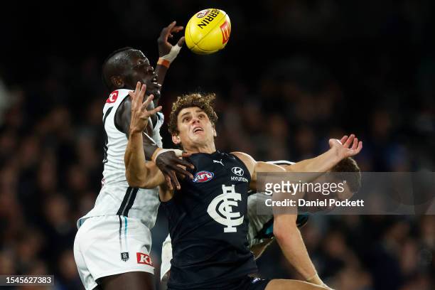 Charlie Curnow of the Blues marks the ball against Aliir Aliir of the Power during the round 18 AFL match between Carlton Blues and Port Adelaide...