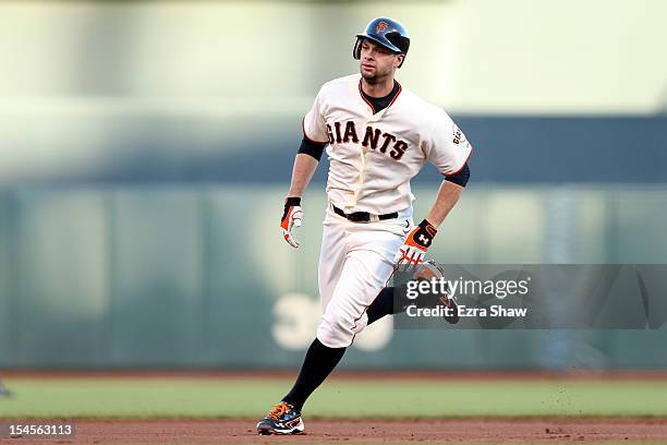 Brandon Belt of the San Francisco Giants runs to third base against the St. Louis Cardinals in Game Six of the National League Championship Series at...
