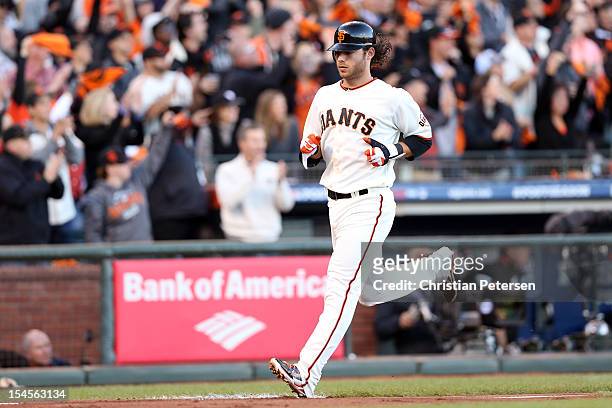 Brandon Crawford of the San Francisco Giants scores against the St. Louis Cardinals in Game Six of the National League Championship Series at AT&T...