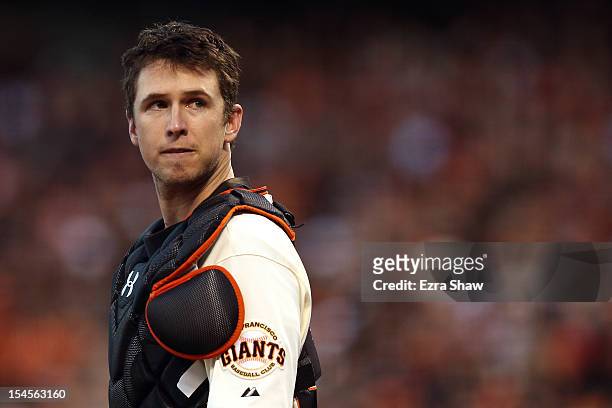 Catcher Buster Posey of the San Francisco Giants looks on in the fourth inning while taking on the St. Louis Cardinals in Game Six of the National...
