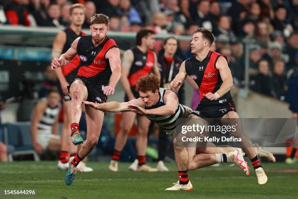 Jayden Laverde of the Bombers collides with Gary Rohan of the Cats and Zach Merrett of the Bombers during the round 18 AFL match between Geelong Cats...