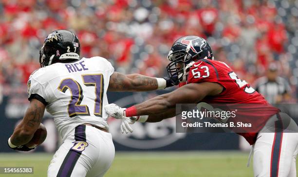Ray Rice of the Baltimore Ravens breaks the tackle of Bradie James of the Houston Texans on October 21, 2012 at Reliant Stadium in Houston, Texas....