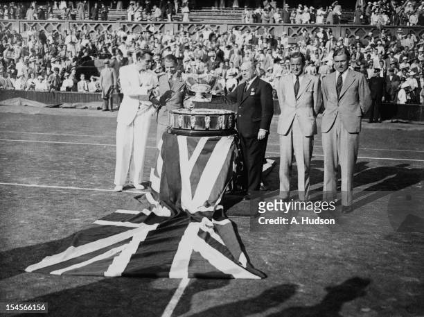 The British team with the trophy on the Centre Court at Wimbledon after retaining the Davis Cup, London, 30th July 1935. Left to right: Fred Perry ,...