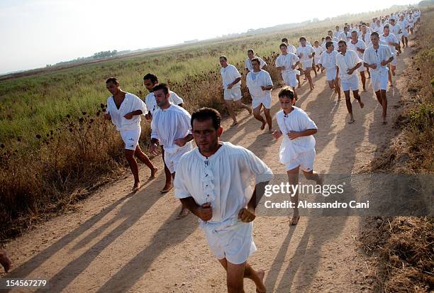 Men running along the fields during San Salvatore Feast, in Cabras , Sardinia - Italy