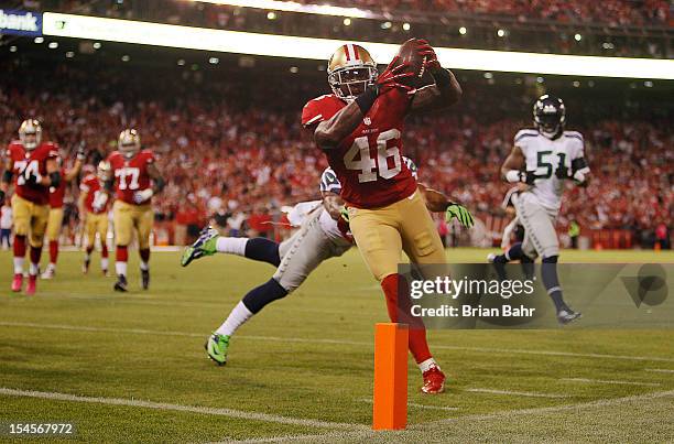 Tight end Delanie Walker of the San Francisco 49ers catches a 4-yard pass and runs 8-yards for touchdown against free safety Earl Thomas the Seattle...