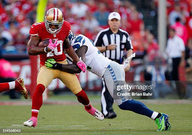 Wide receiver Kyle Williams of the San Francisco 49ers twists away from defensive end Chris Clemons of the Seattle Seahawks in the first quarter on...