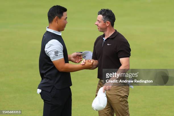 Tom Kim of South Korea and Rory McIlroy of Northern Ireland shake hands on the 18th green after finishing their round during Day Three of the Genesis...