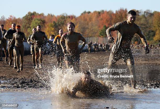 Participants compete in the Tough Mudder event at Raceway Park on October 21, 2012 in Englishtown, New Jersey.