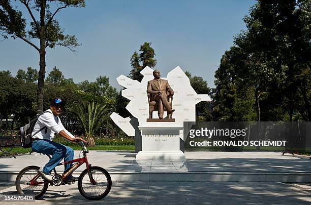 Man rides a bike in front of a sculpture of former president of Azerbaijan Heydar Aliyev on October 22 at the Reforma avenue, in Mexico City. AFP...