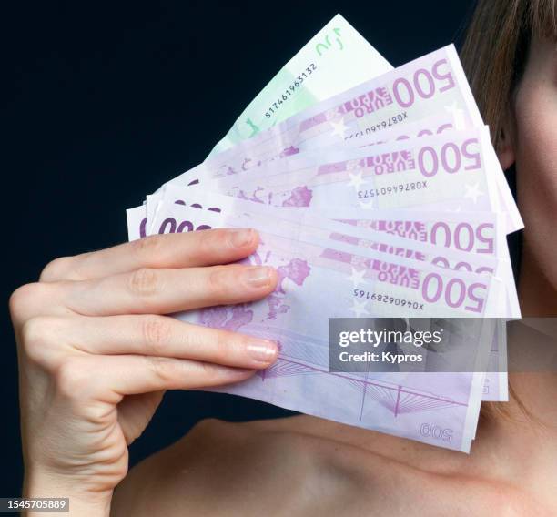 human hand holding cash money banknotes - five hundred euro banknote stock pictures, royalty-free photos & images